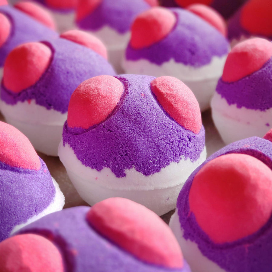 Purple, pink, and white Master Ball bath bombs arranged together