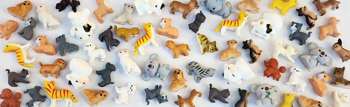 Assorted animal figurines arranged on a white background