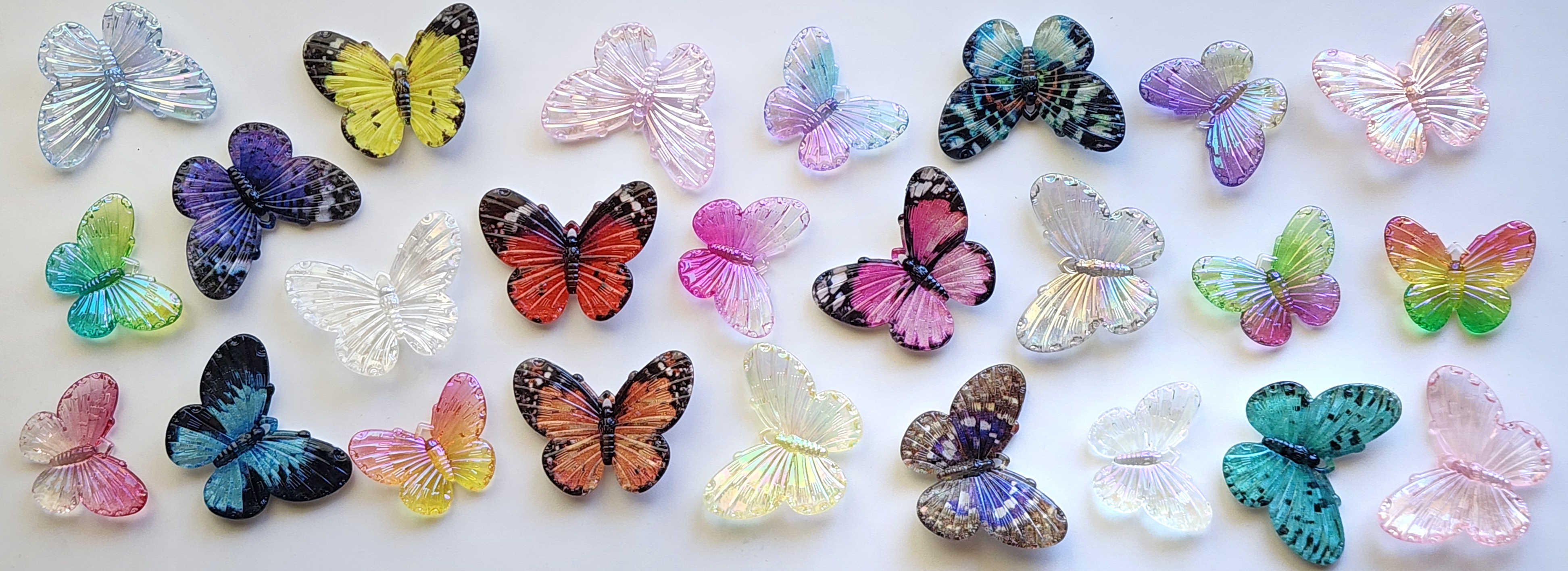 Colorful translucent butterfly figurines arranged on a white background