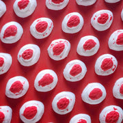 Mini red and white bath bomb inspired by the berry and cream soft lolly from the classic australian party mix