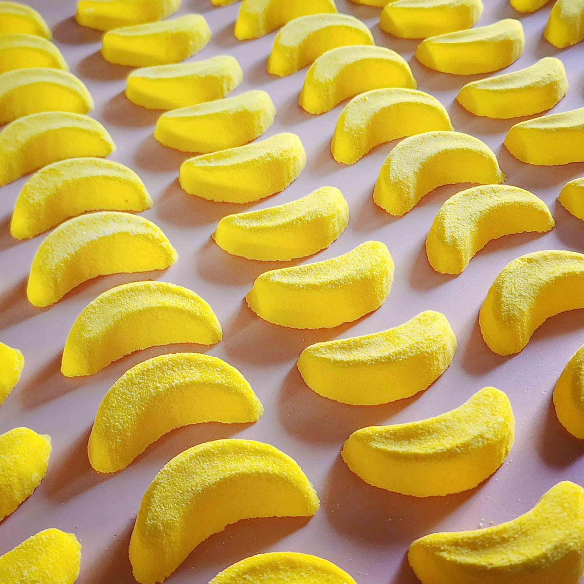 Mini banana shaped bath bomb shaped as iconic australian party mix lolly