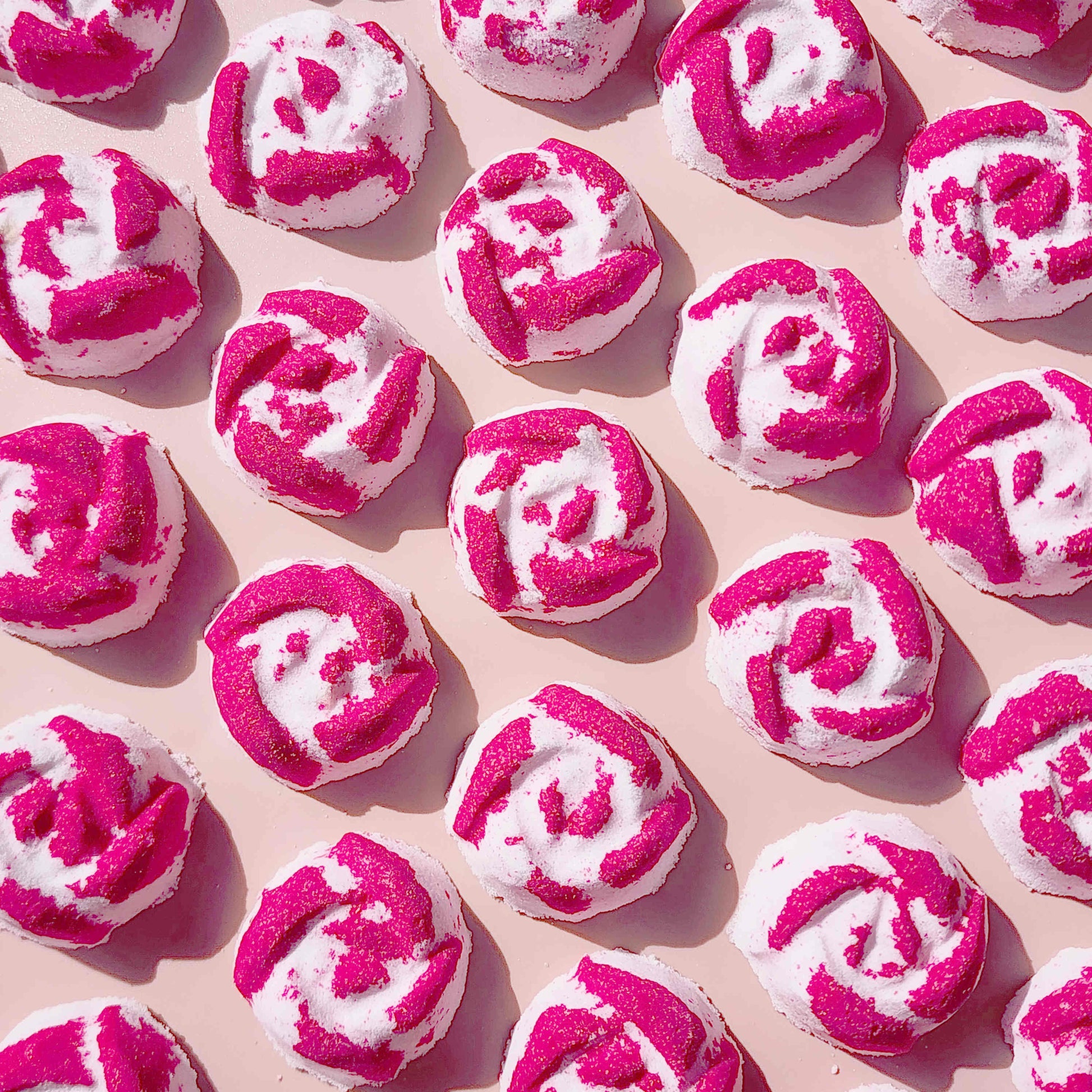 Overhead pattern of pink and white Peony Rose mini bath bombs