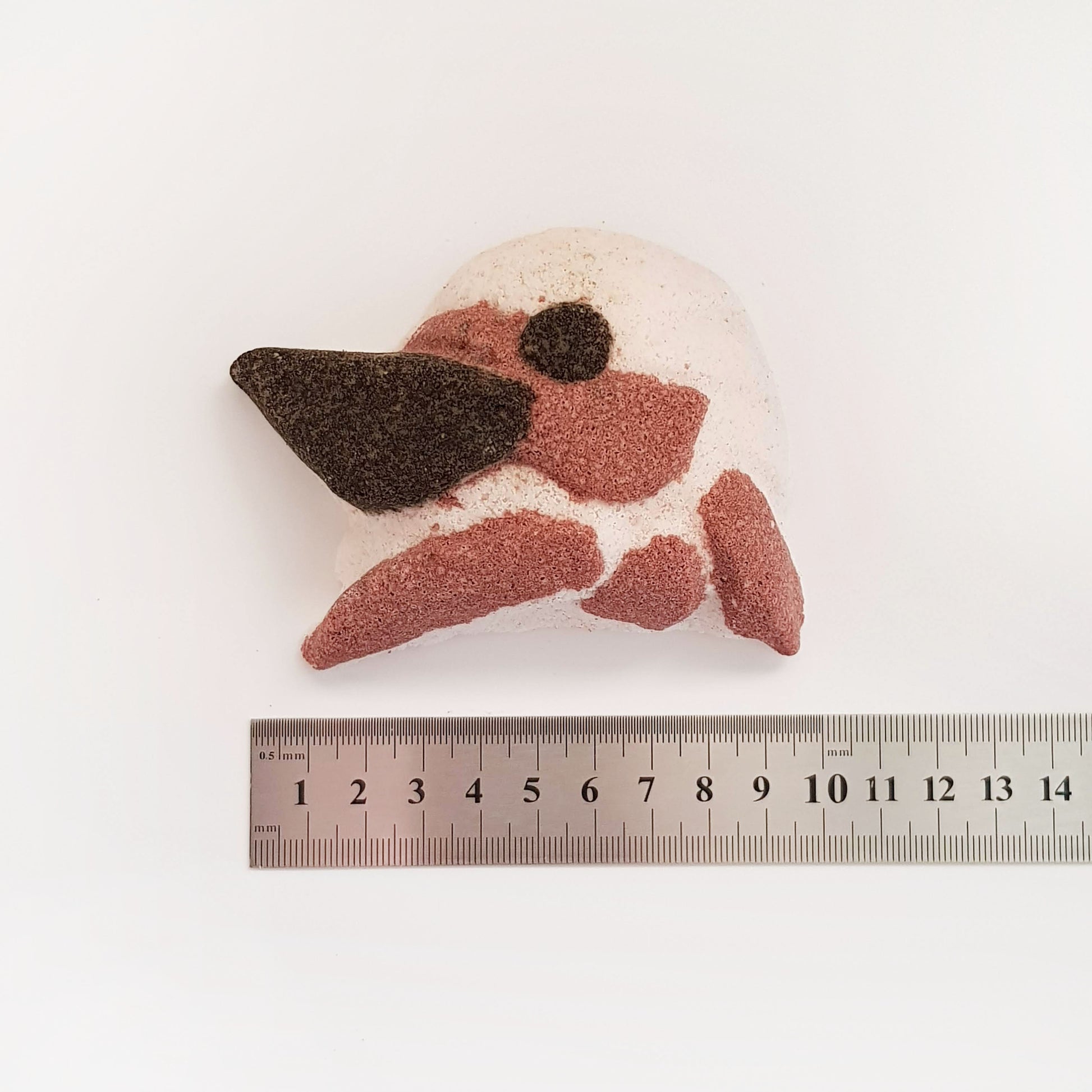 Paperbark Kookaburra-shaped bath bomb measured beside a ruler
