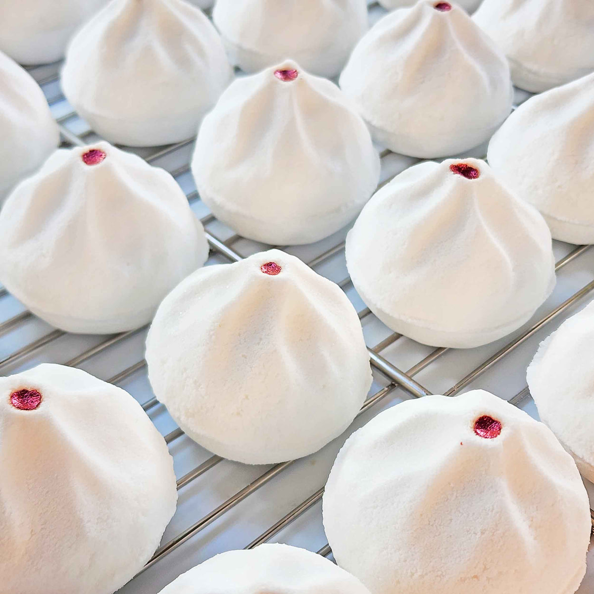 Tray of white Yum Cha bao bath bombs cooling on a rack
