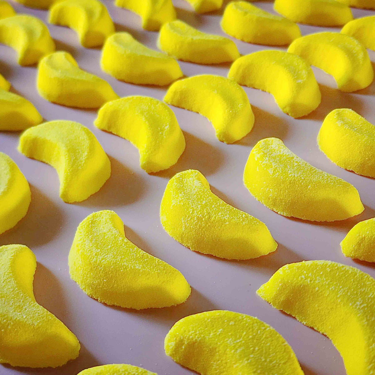 Mini banana shaped bath bomb shaped as iconic australian party mix lolly