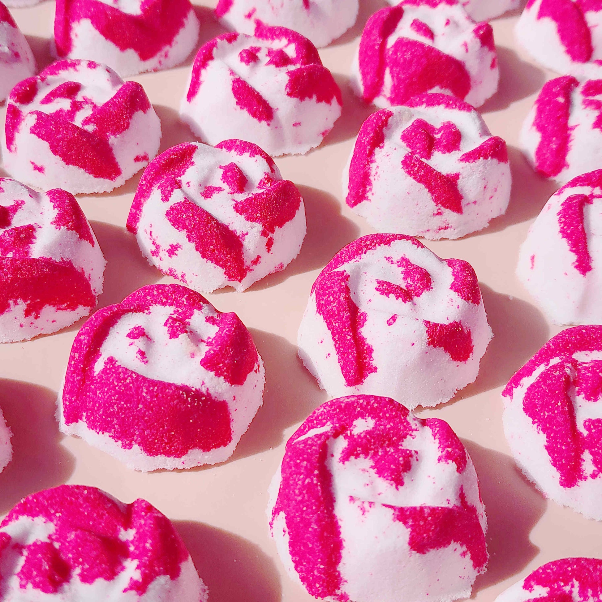 Close-up of pink and white Peony Rose mini bath bombs