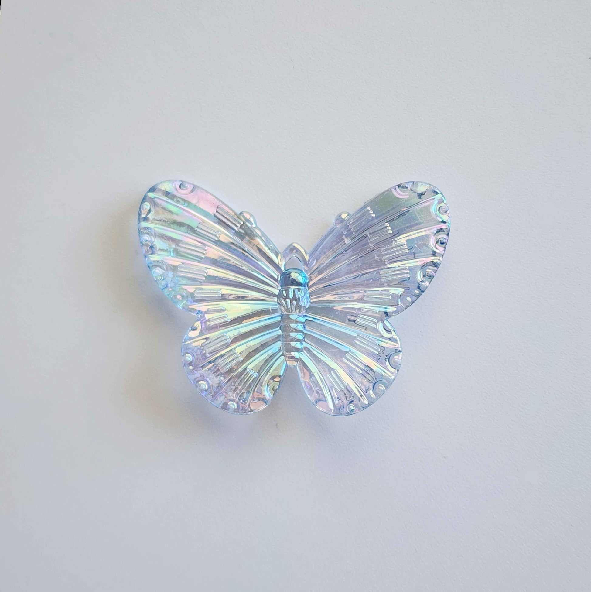 faintly blue pigmented clear iridescent butterfly charm