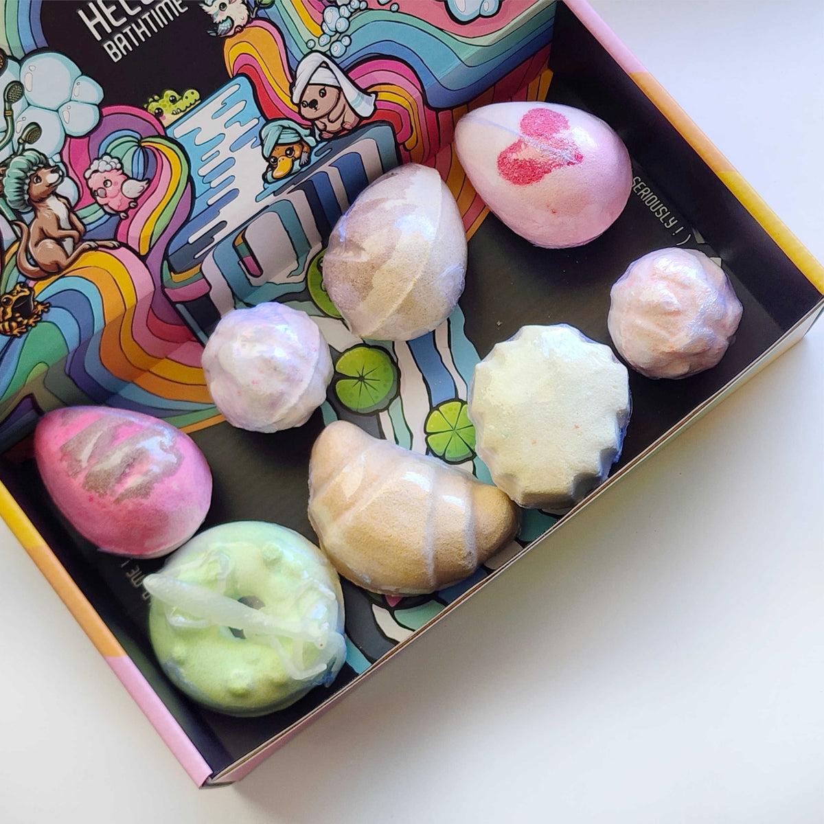 Open Oopsie Surprise Box filled with a colorful mix of bath bombs