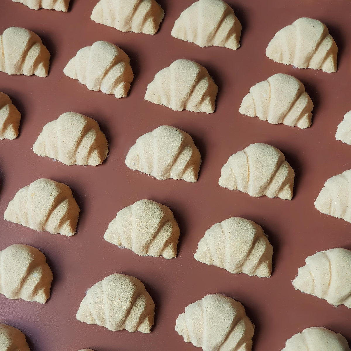 mini golden brown coloured croissant shaped bath bomb