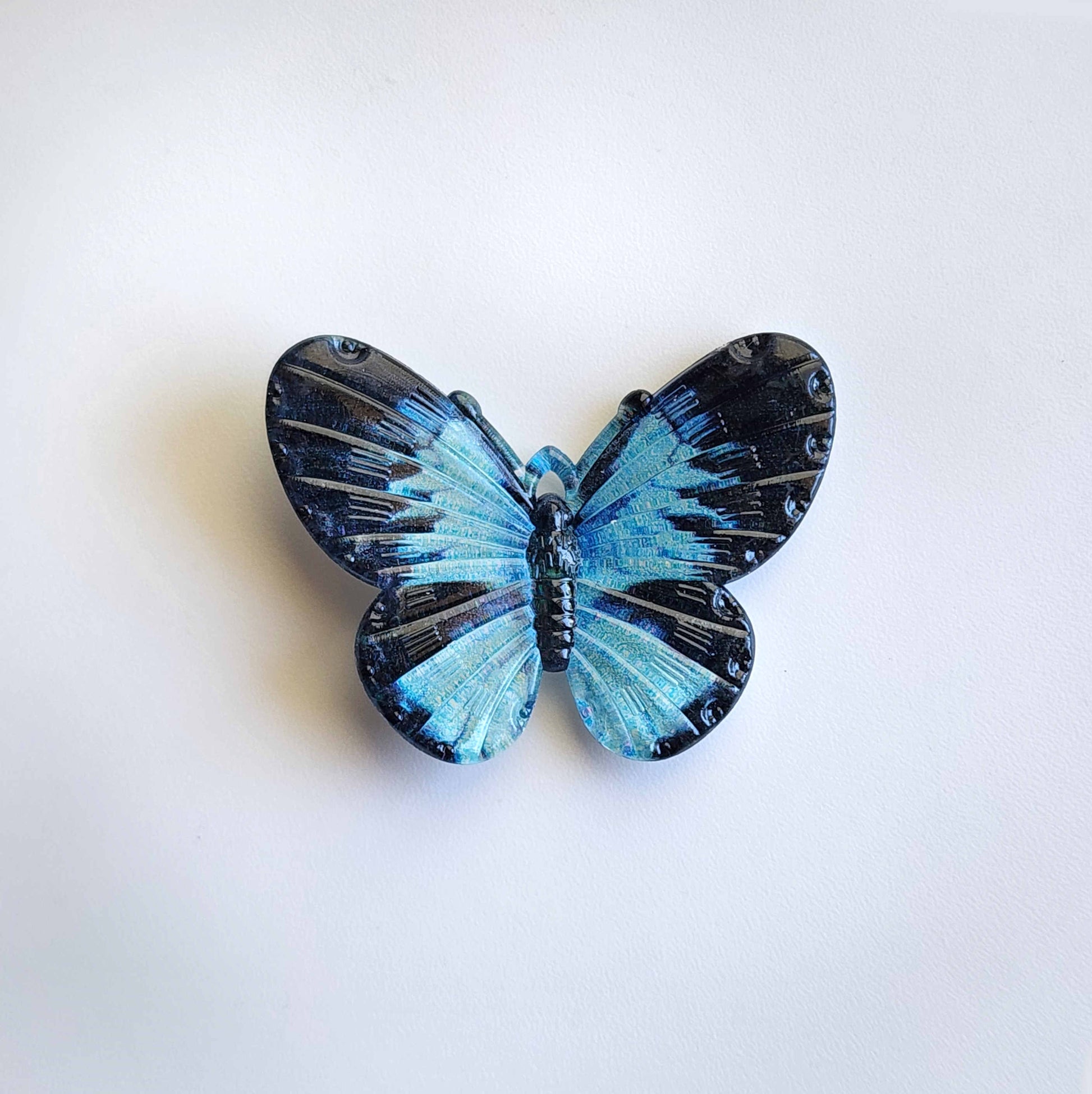 light blue and black acrylic butterfly charm