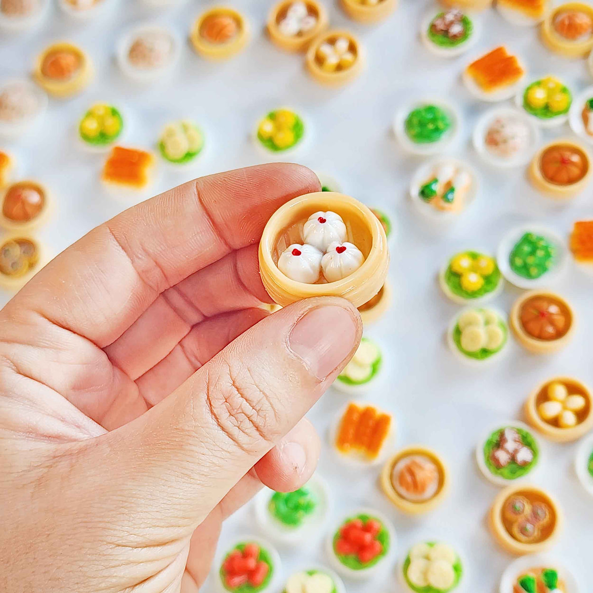 Hand holding a miniature steamed-bun surprise toy