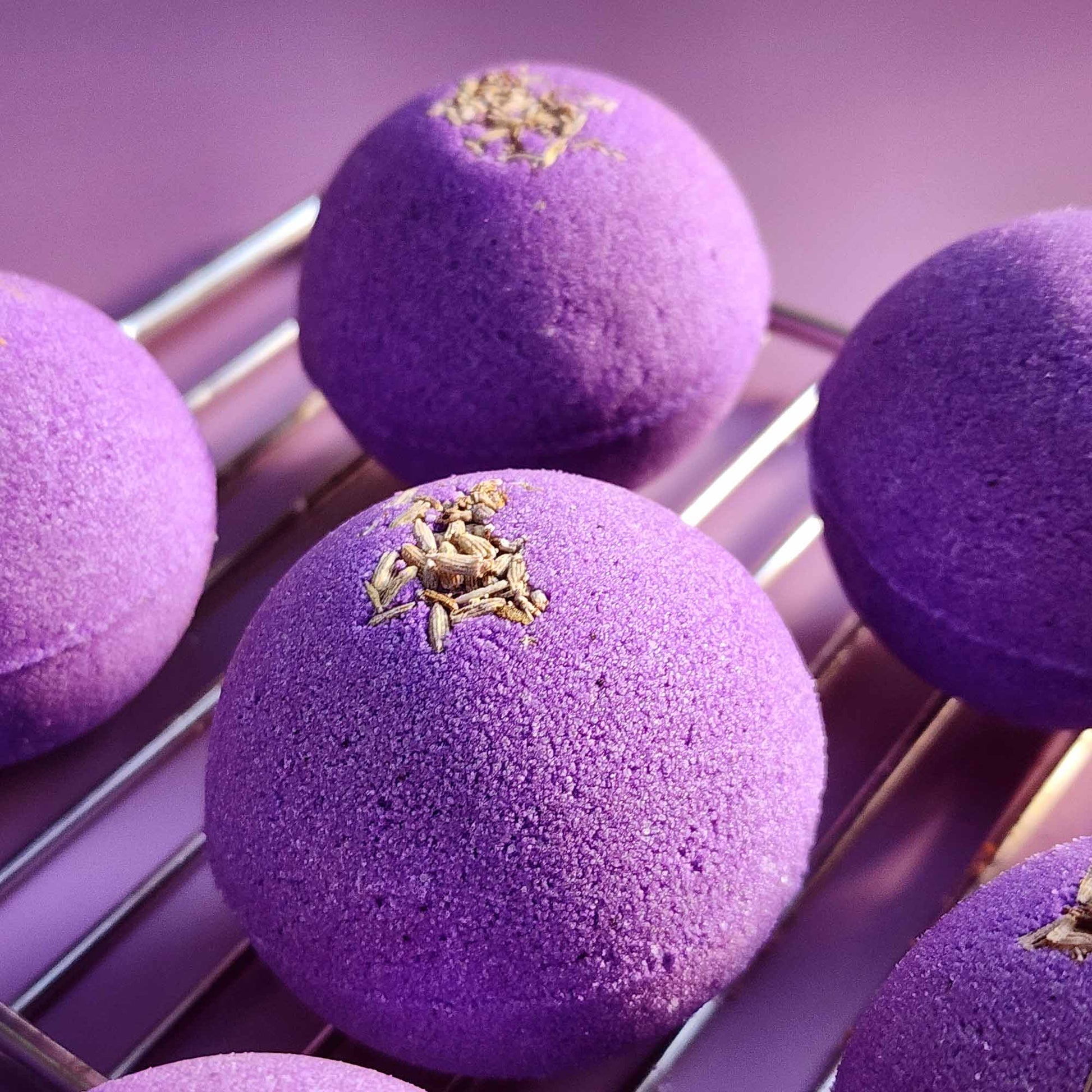 Detailed view of purple Relax bath bombs topped with dried lavender