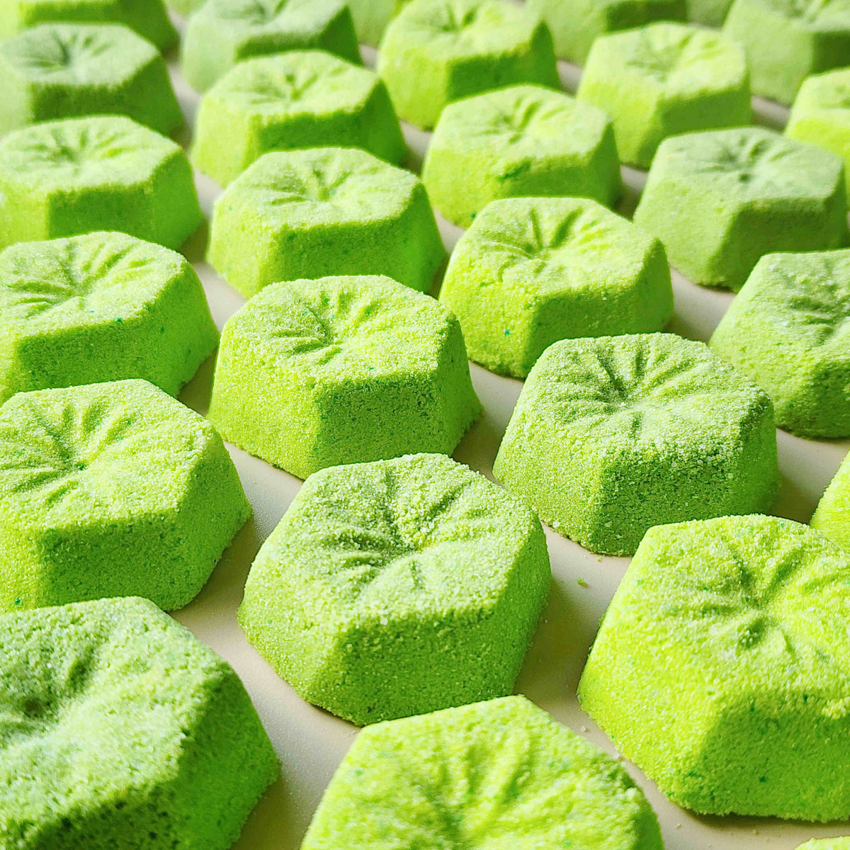 Close-up of green kiwi-slice mini bath bombs