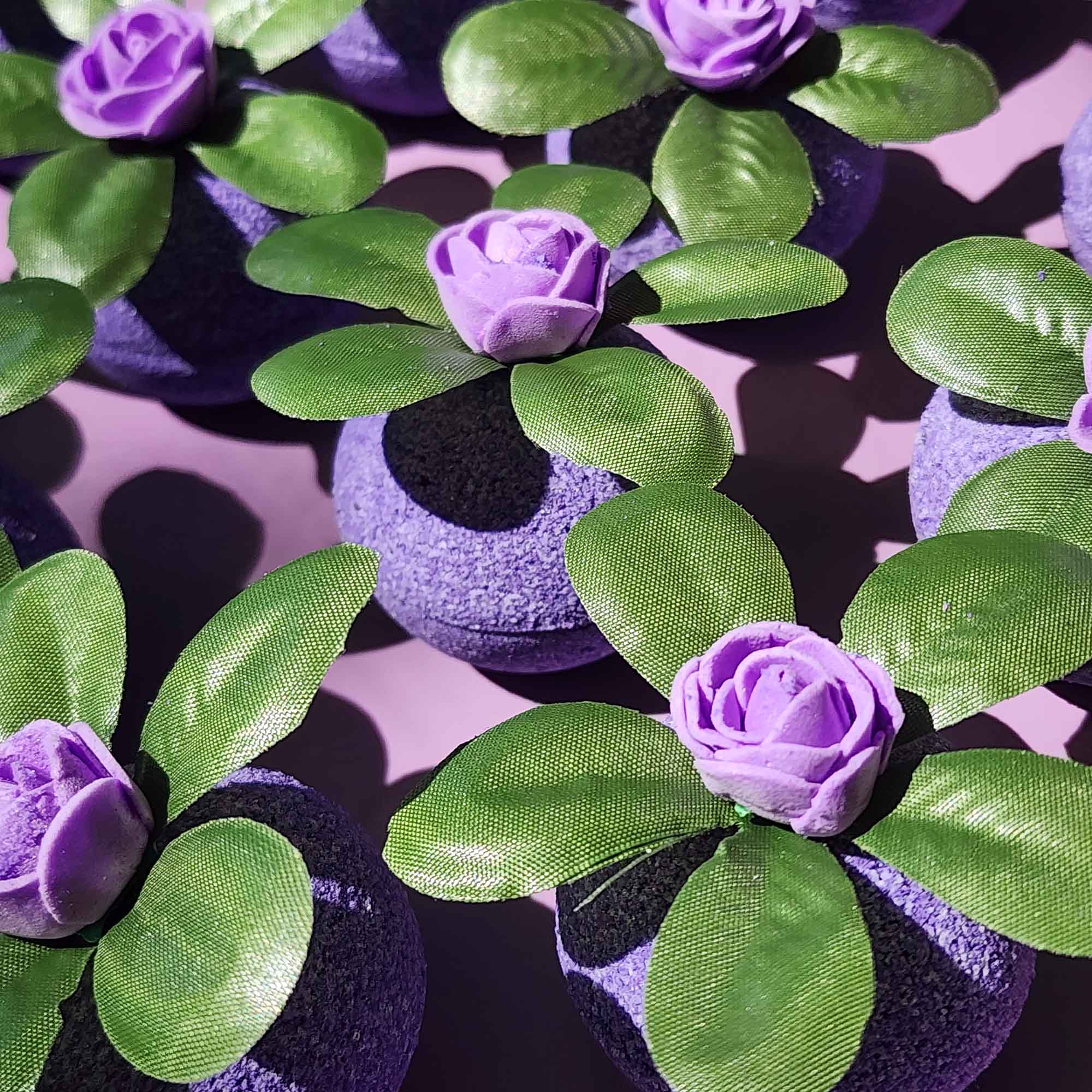 Purple Wild Berry bath bombs topped with green leaves and violet roses