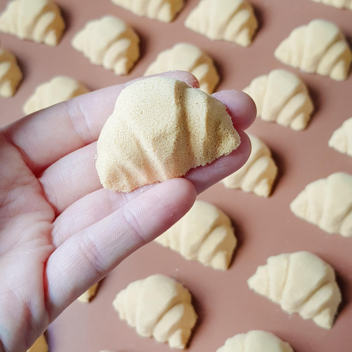 mini golden brown coloured croissant shaped bath bomb