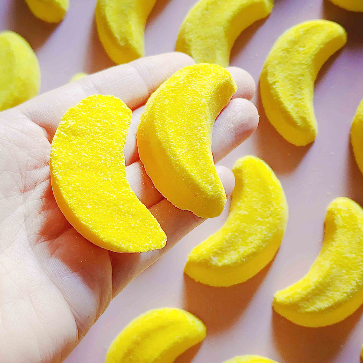 Mini banana shaped bath bomb shaped as iconic australian party mix lolly