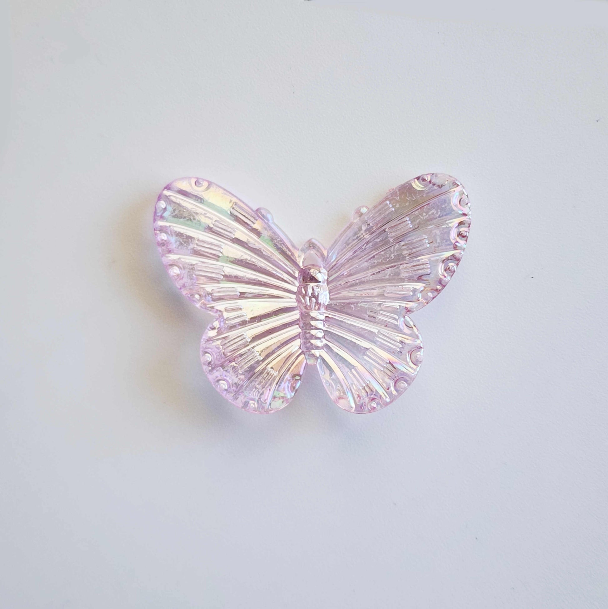 faintly cool pink pigmented clear iridescent butterfly charm
