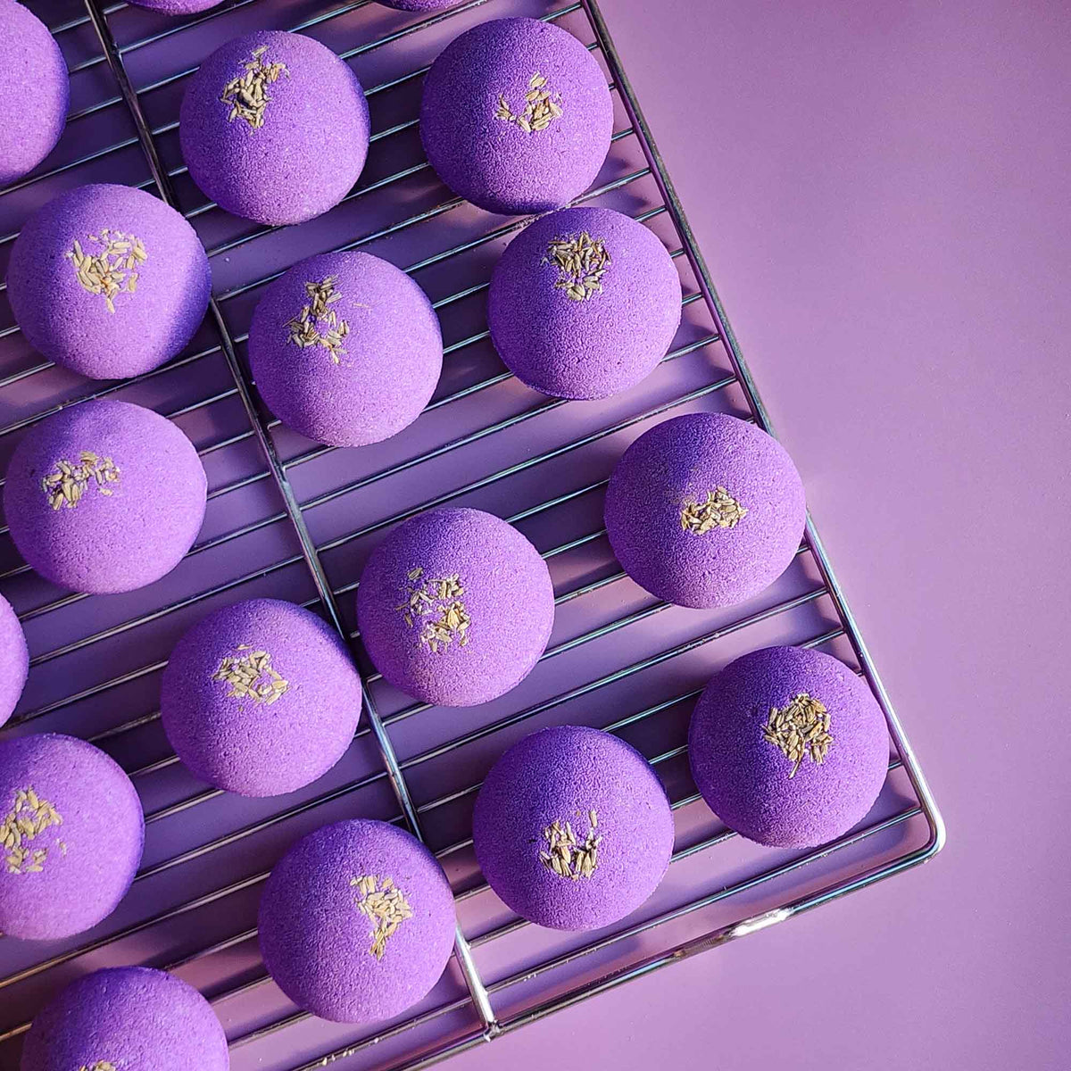 Tray of purple Relax aromatherapy bath bombs topped with lavender