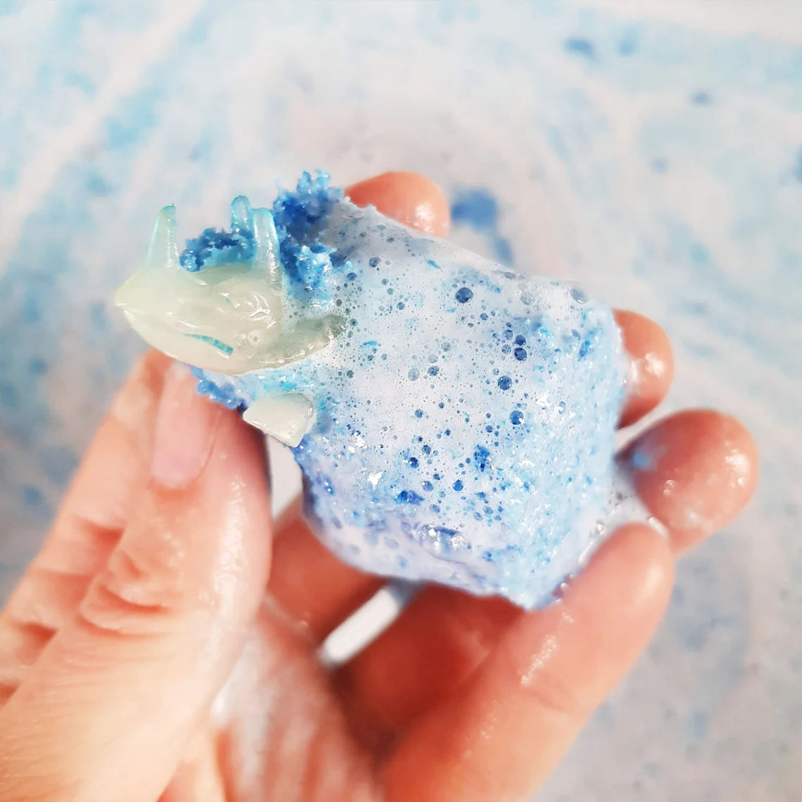 dinosaur toy in a bath bomb