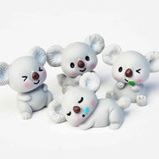 Cute grey koala resin figurines on a white background