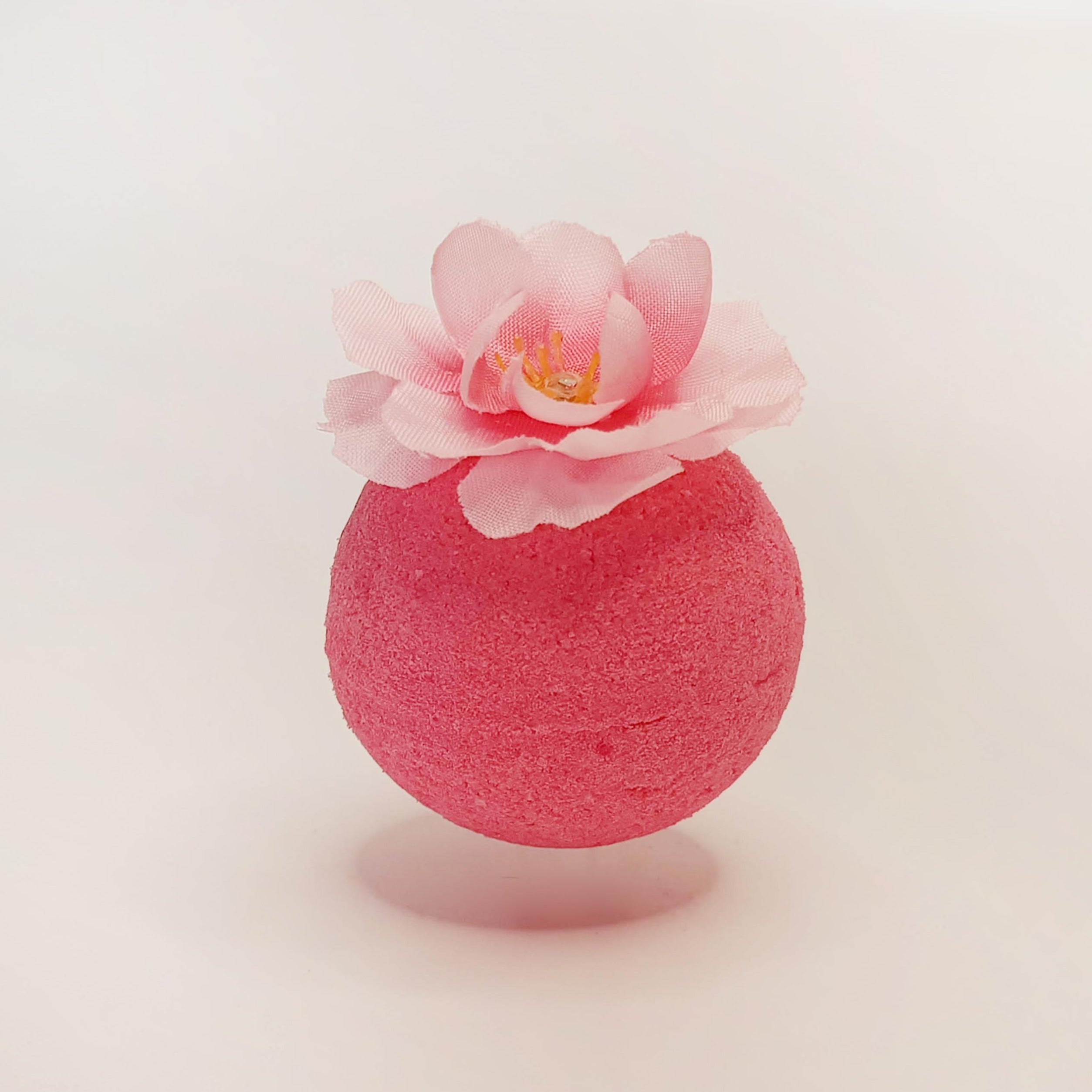 Pink Plum Blossom classic bath bomb topped with a pale pink flower