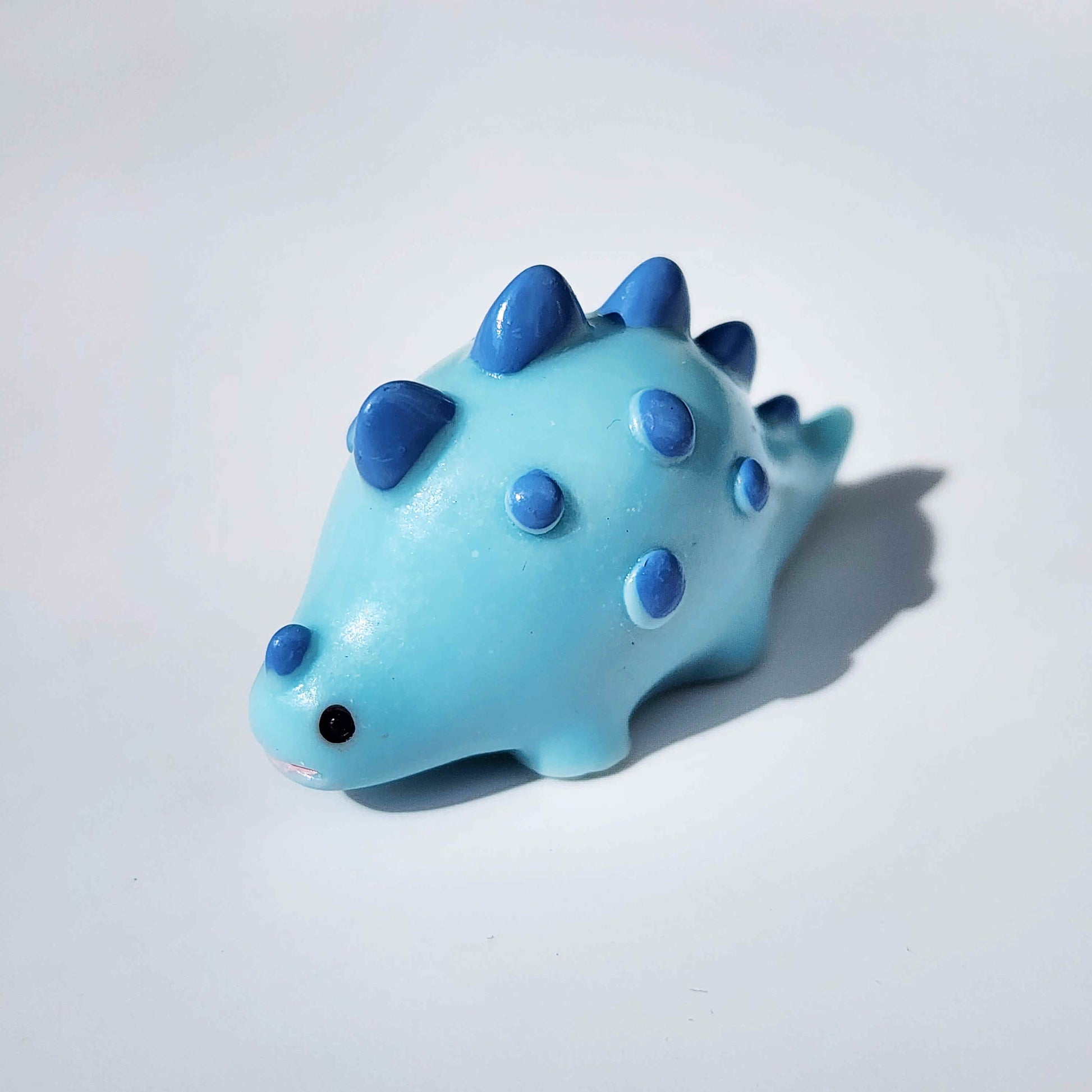 fat blue dinosaur on a white background