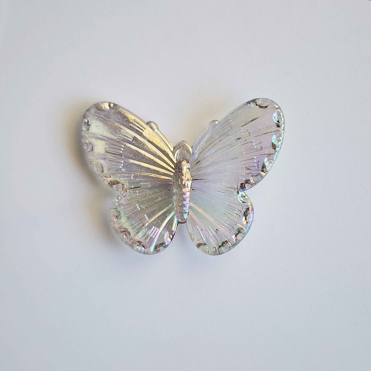 faintly grey pigmented clear iridescent butterfly charm