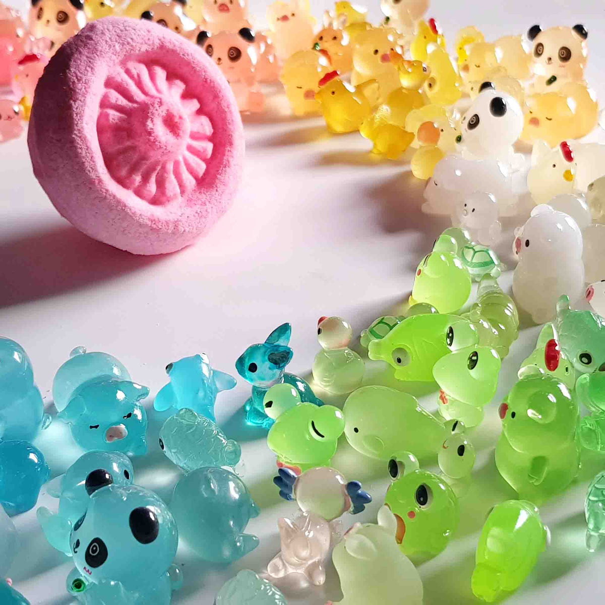 Pink mushroom bath bomb displayed among colorful animal-shaped surprise toys