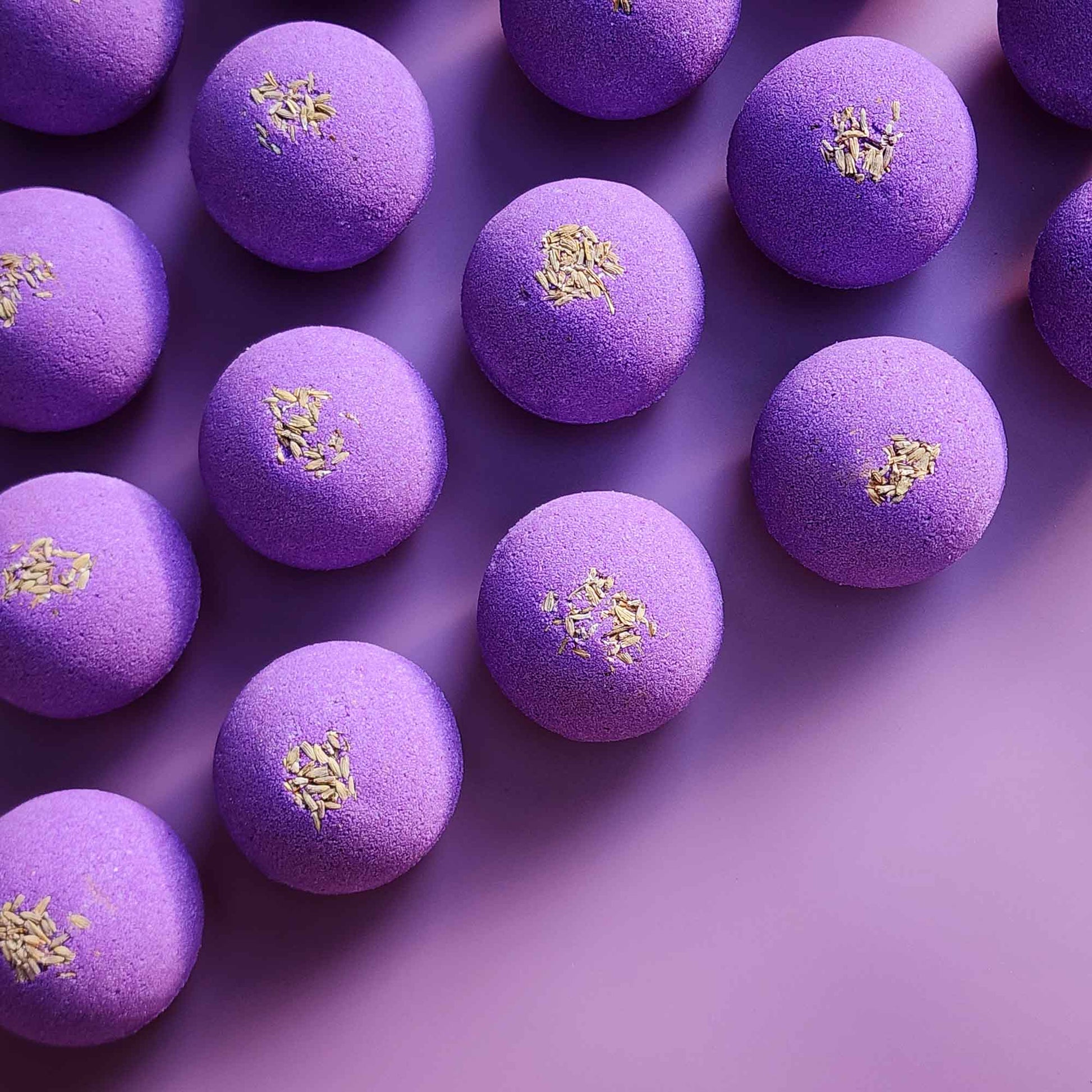 Overhead arrangement of purple Relax aromatherapy bath bombs