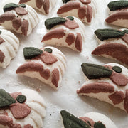 Rows of white, pink, and charcoal Paperbark Kookaburra-shaped bath bombs