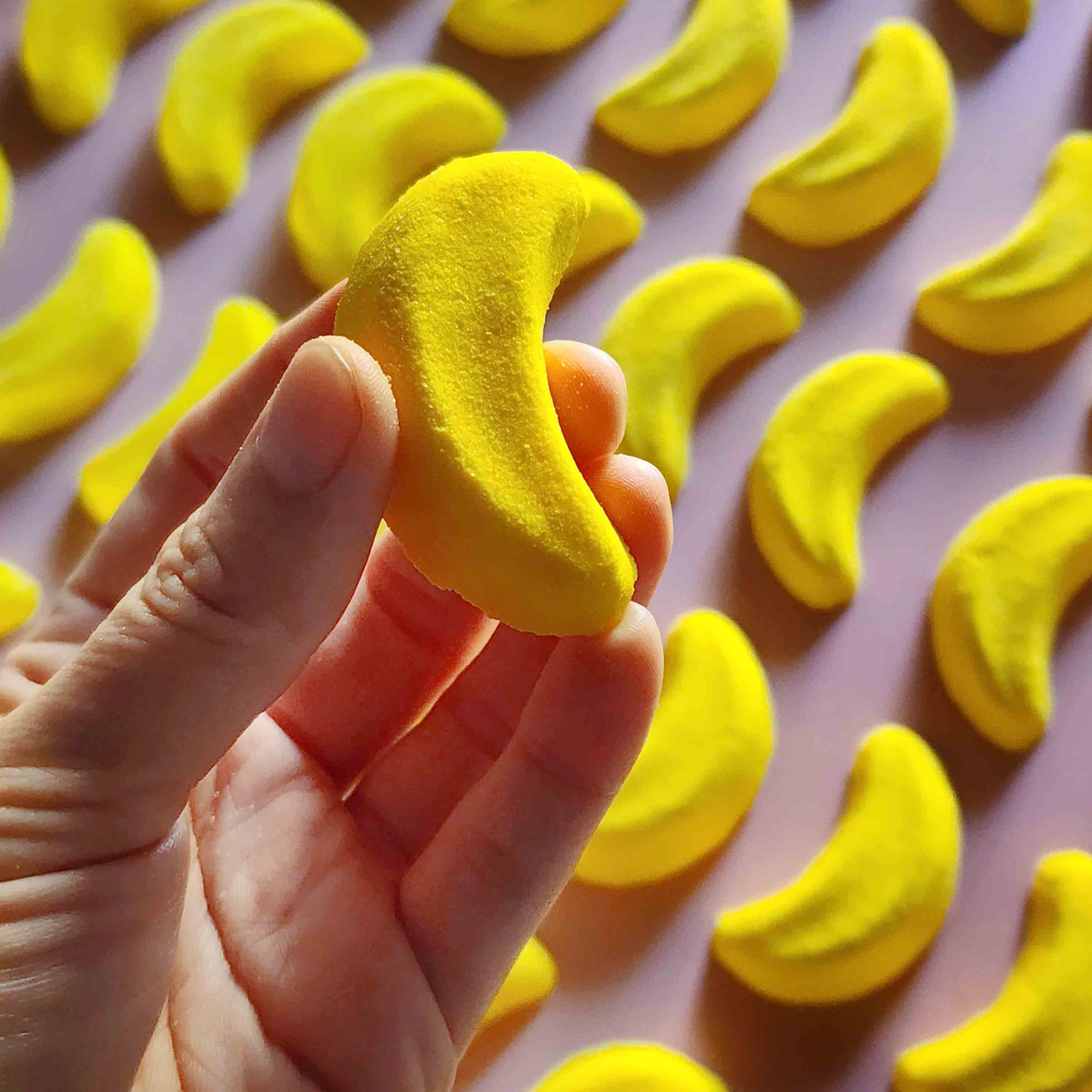 Mini banana shaped bath bomb shaped as iconic australian party mix lolly