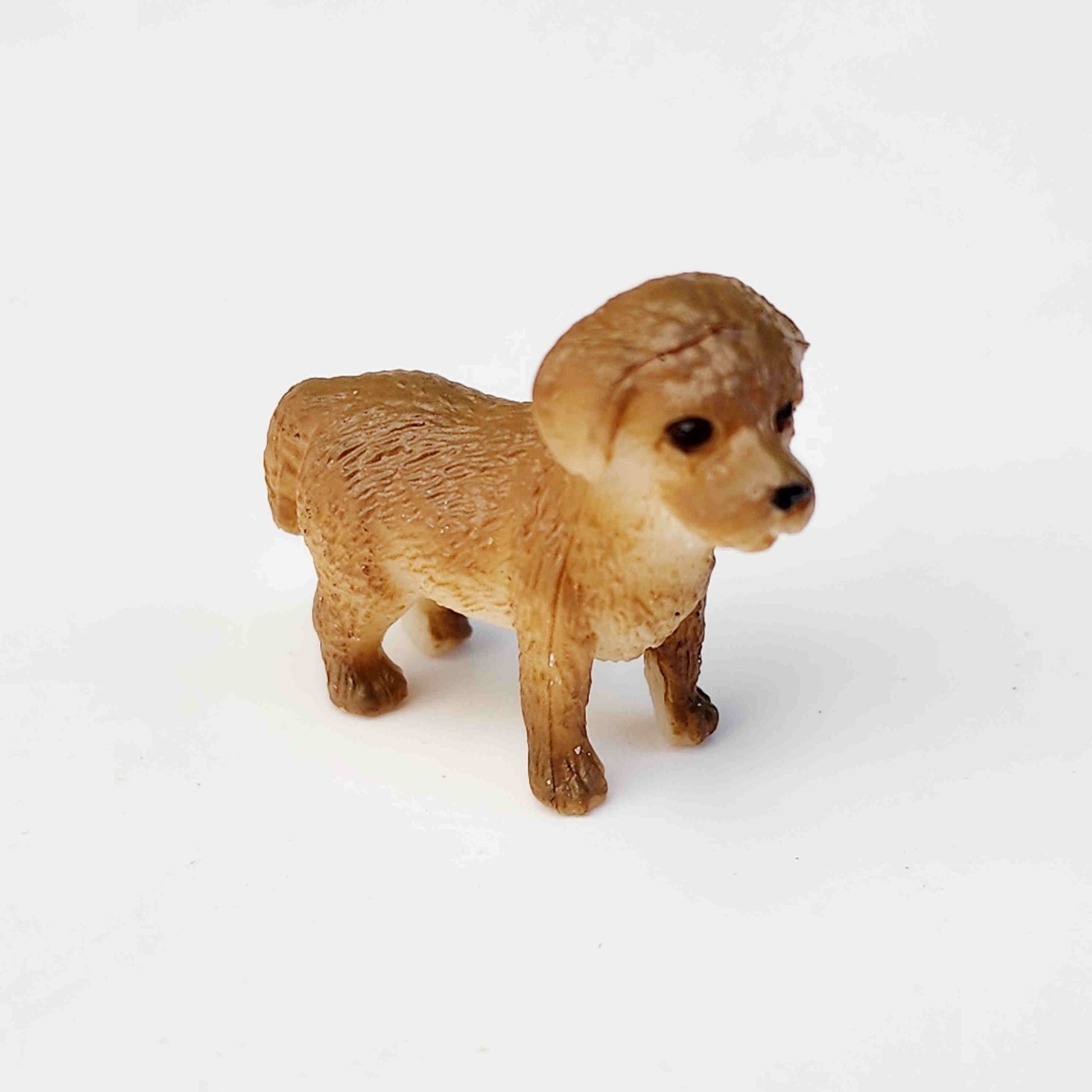 brown coloured pvc dog figurine on a white background