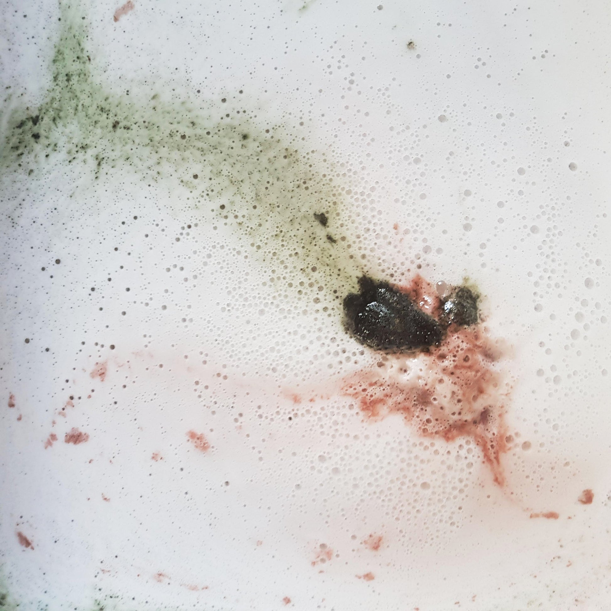 Paperbark Kookaburra bath bomb dissolving in a foamy bath