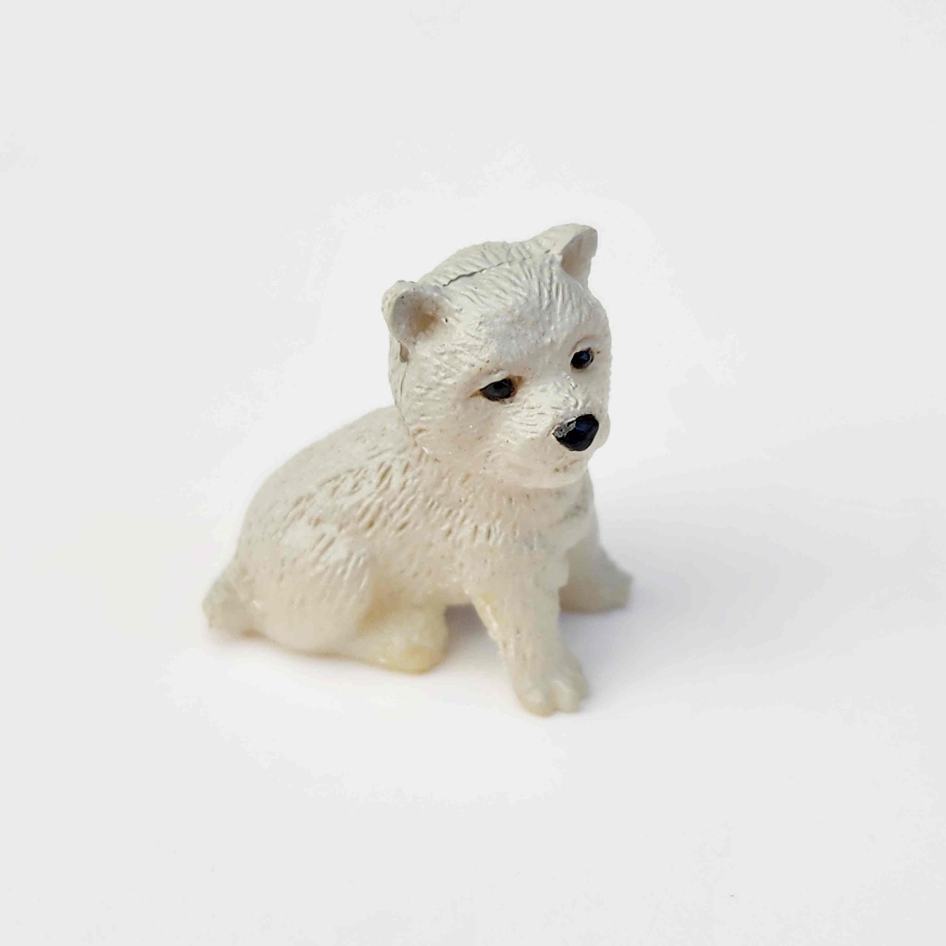 light grey coloured pvc dog figurine on a white background