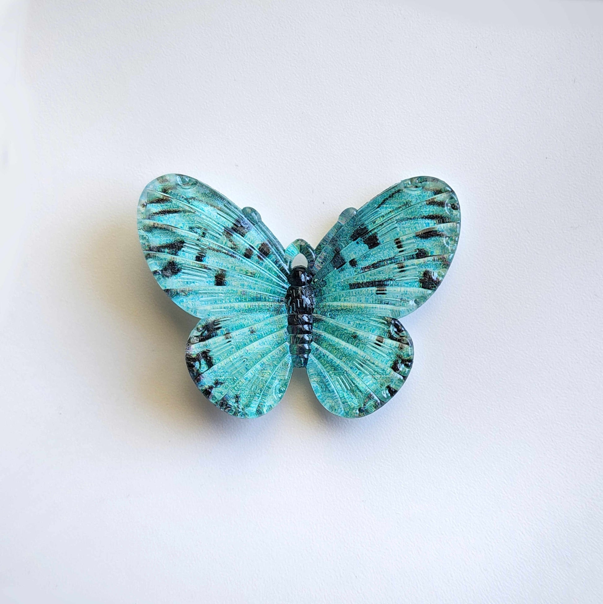 vibrant teal acrylic butterfly charm