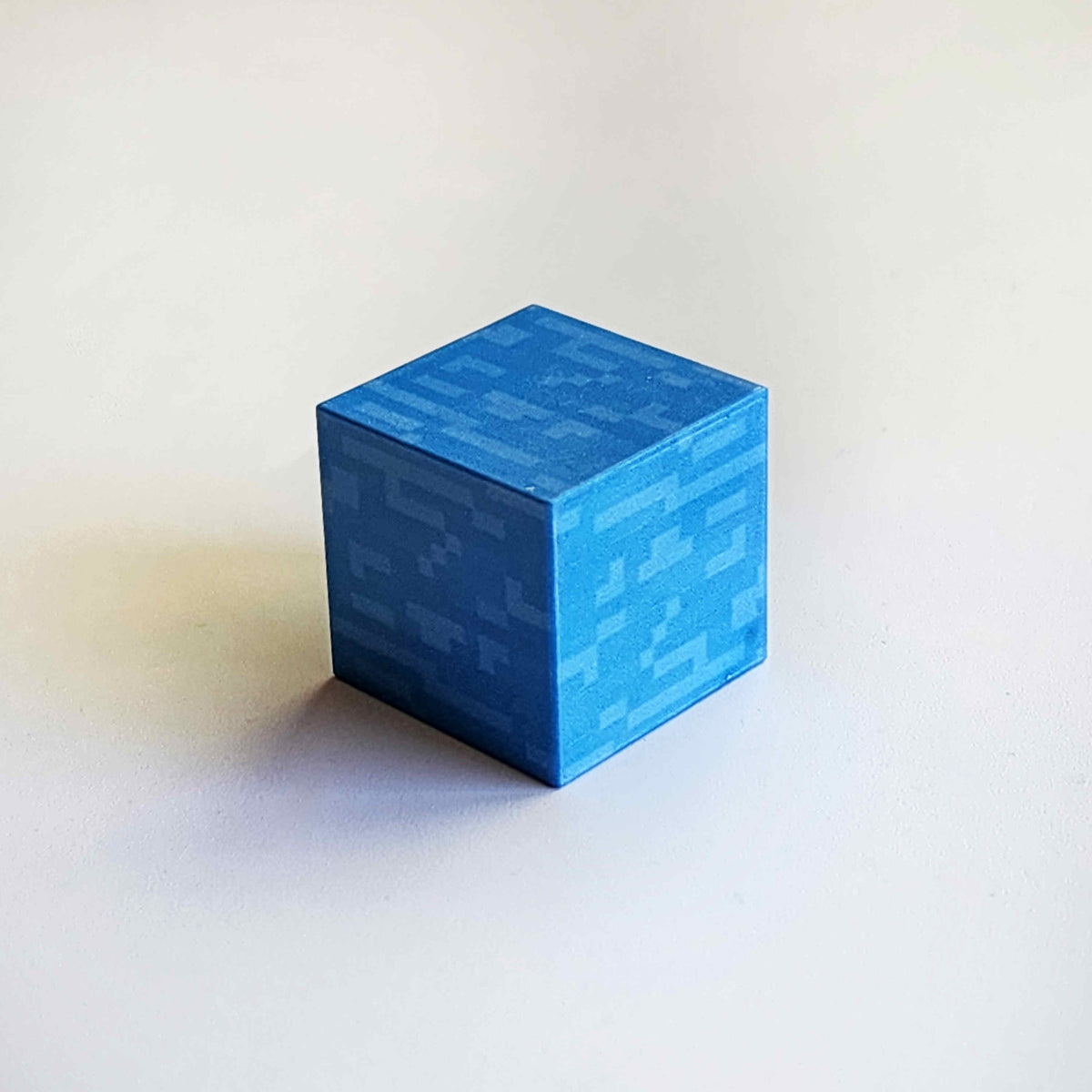water  textured magnetic minecraft building block on a white background
