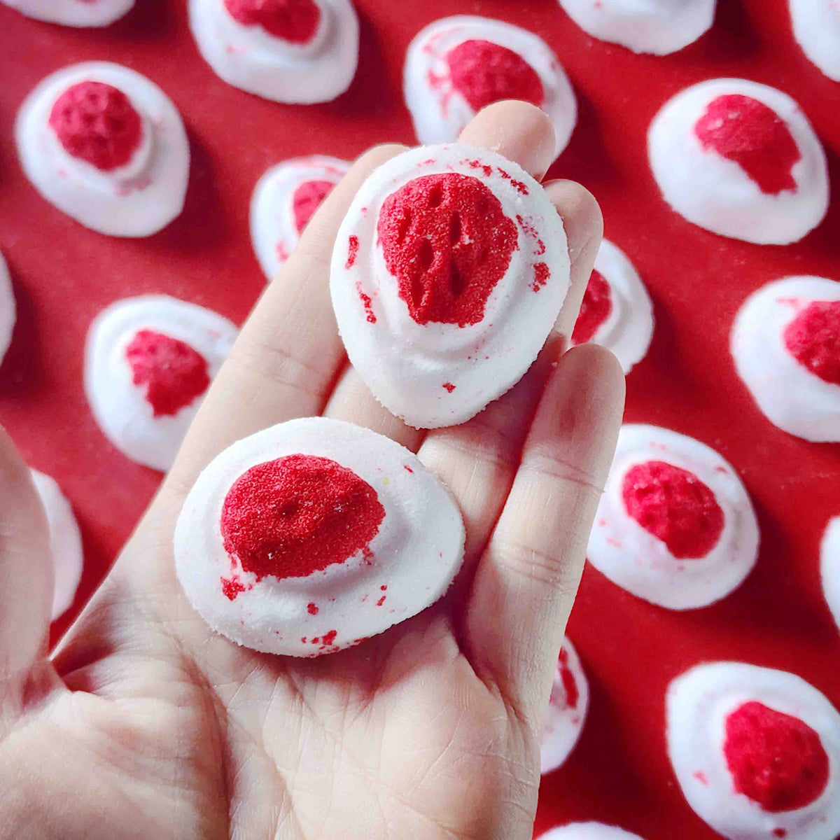 Mini red and white bath bomb inspired by the berry and cream soft lolly from the classic australian party mix