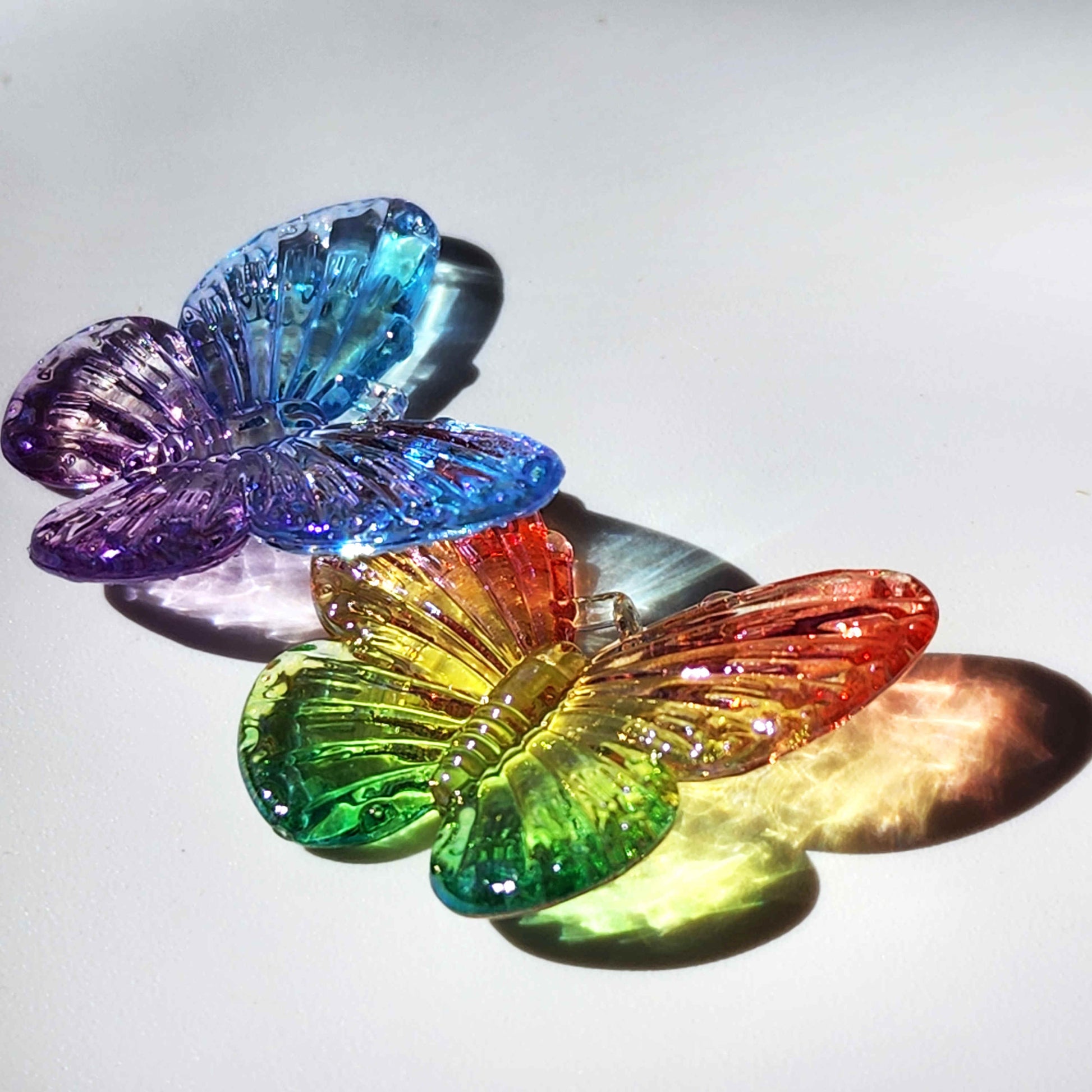 vibrantly coloured transparent butterfly charms refracting sunlight