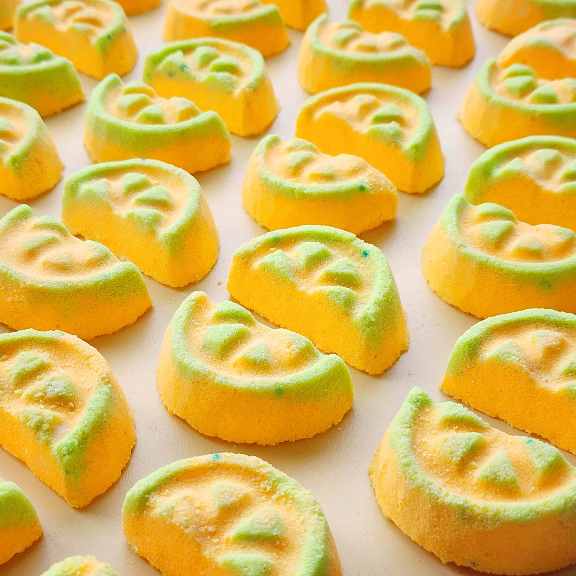 Close-up of yellow and green honeydew mini bath bombs