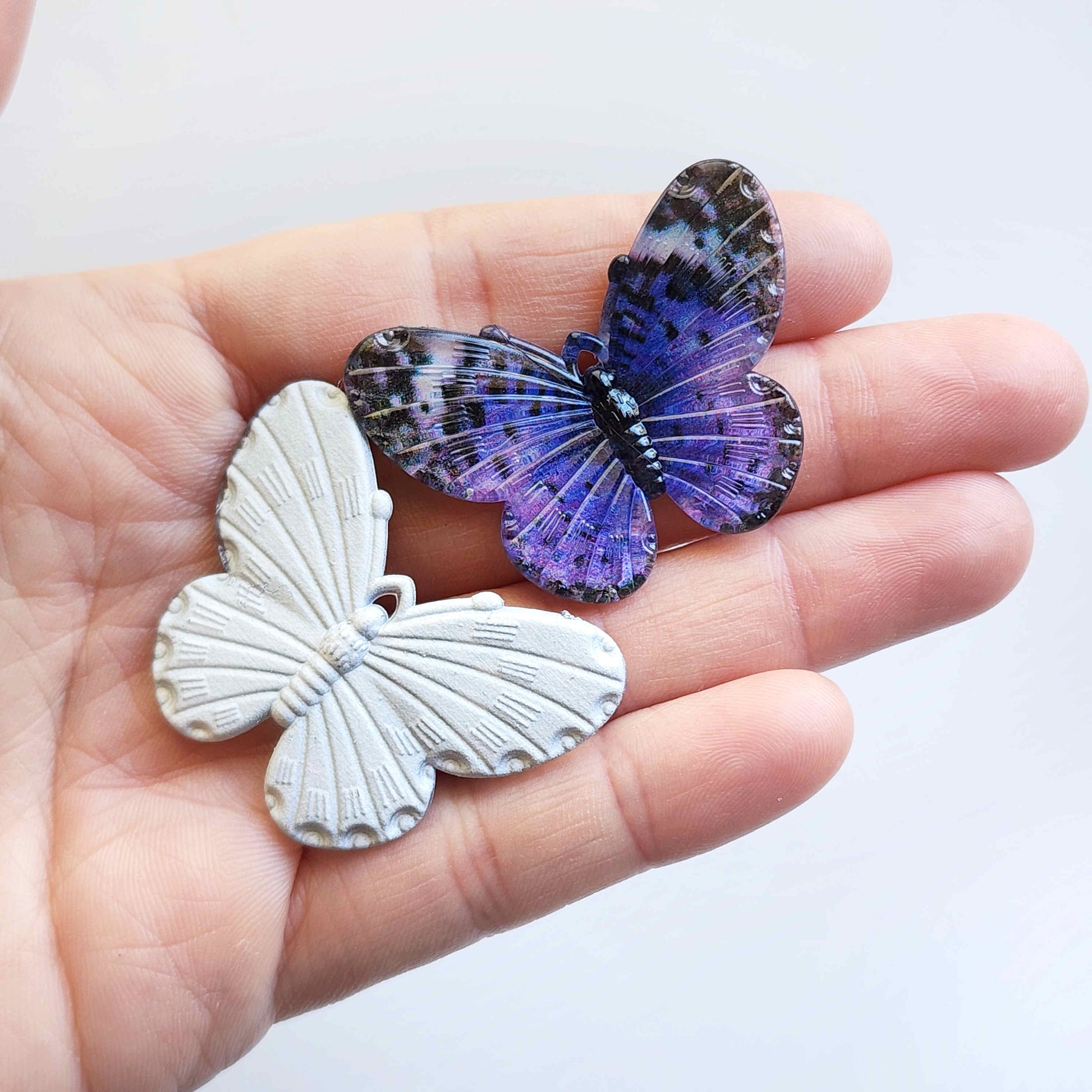 front and back view of a violet acrylic butterfly charm