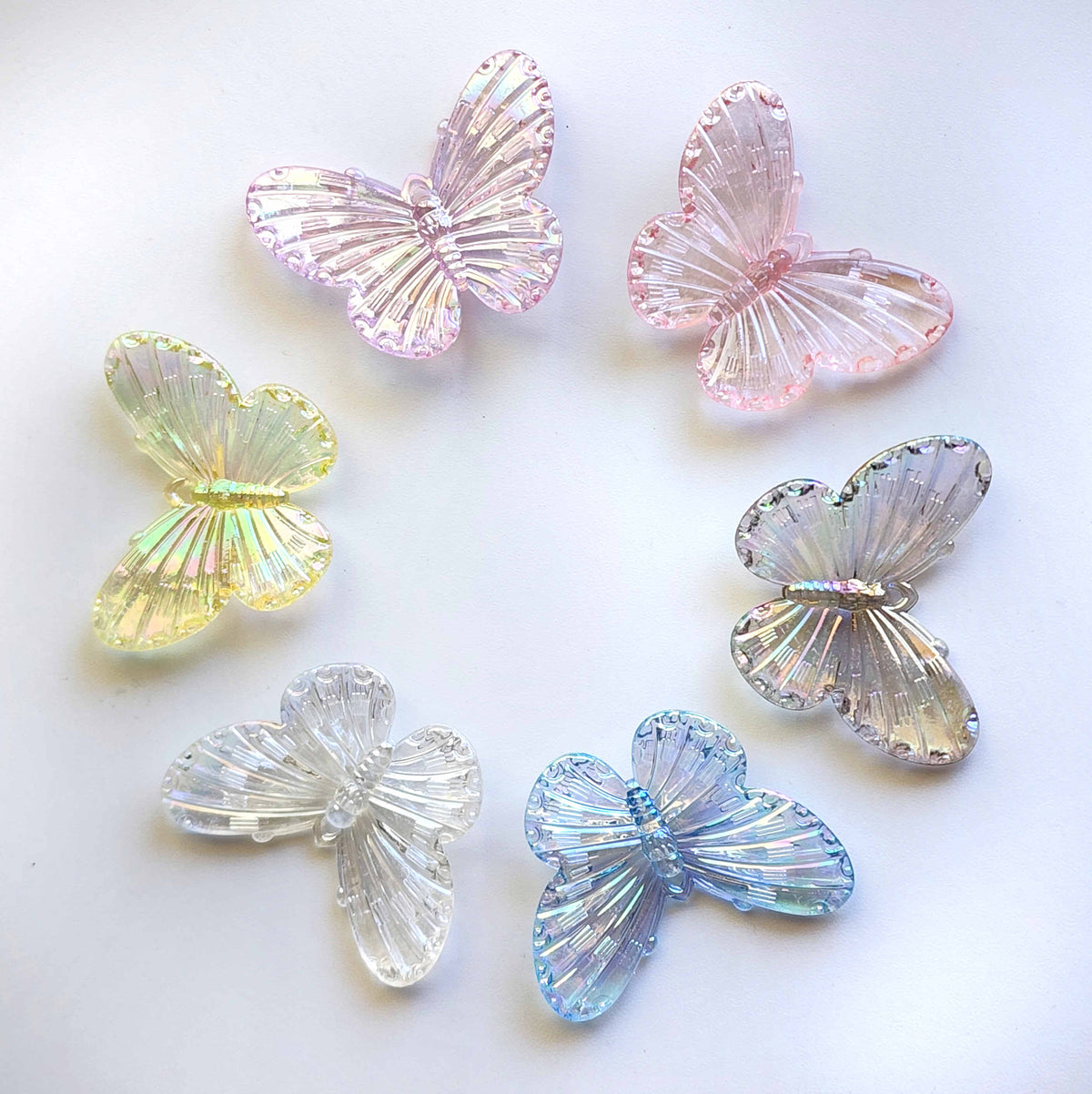 circle of clear iridescent acrylic butterfly charms in all sorts of colours