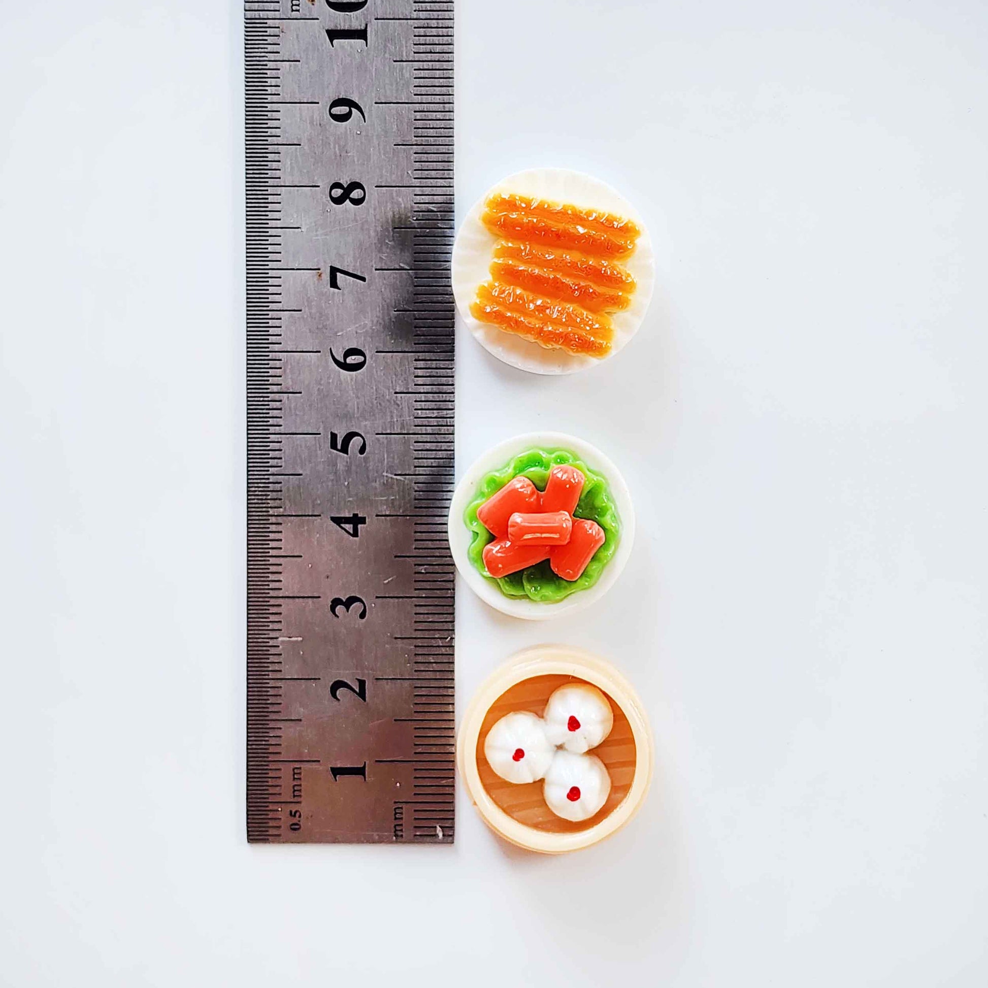 Miniature dim sum surprise toys measured beside a ruler