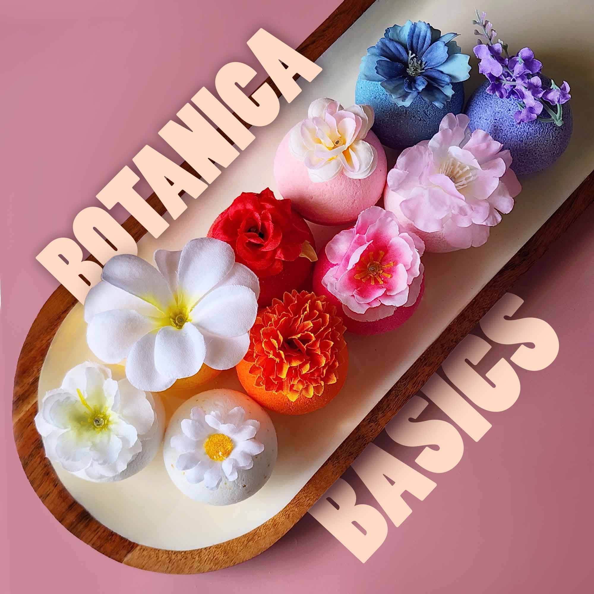 Botanica Basics bath bomb bundle arranged with flowers on a wooden tray
