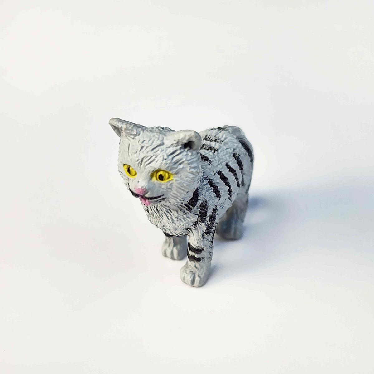 grey tabby pvc cat figurine standing up on a white background