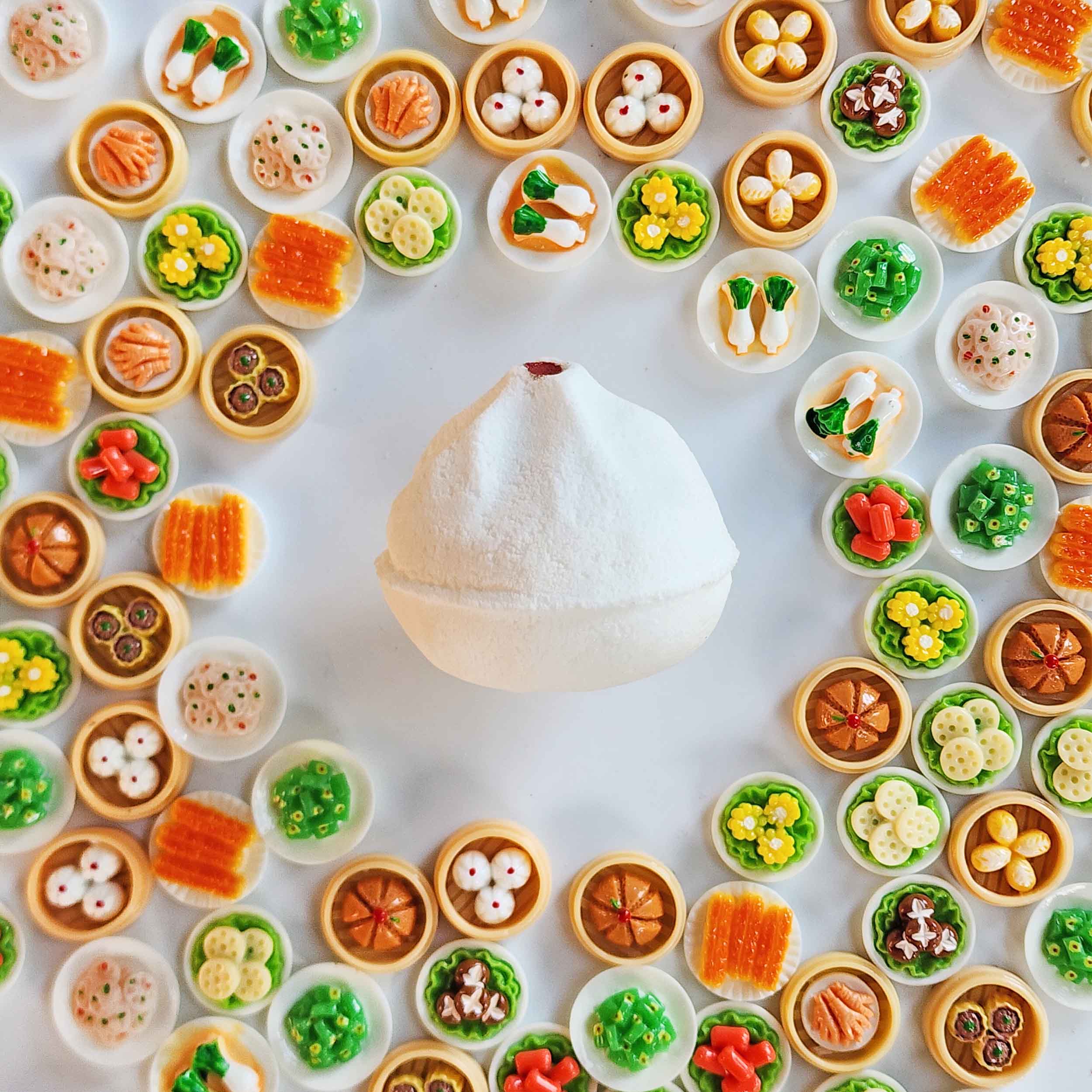 White Yum Cha bao bath bomb surrounded by miniature dim sum toys