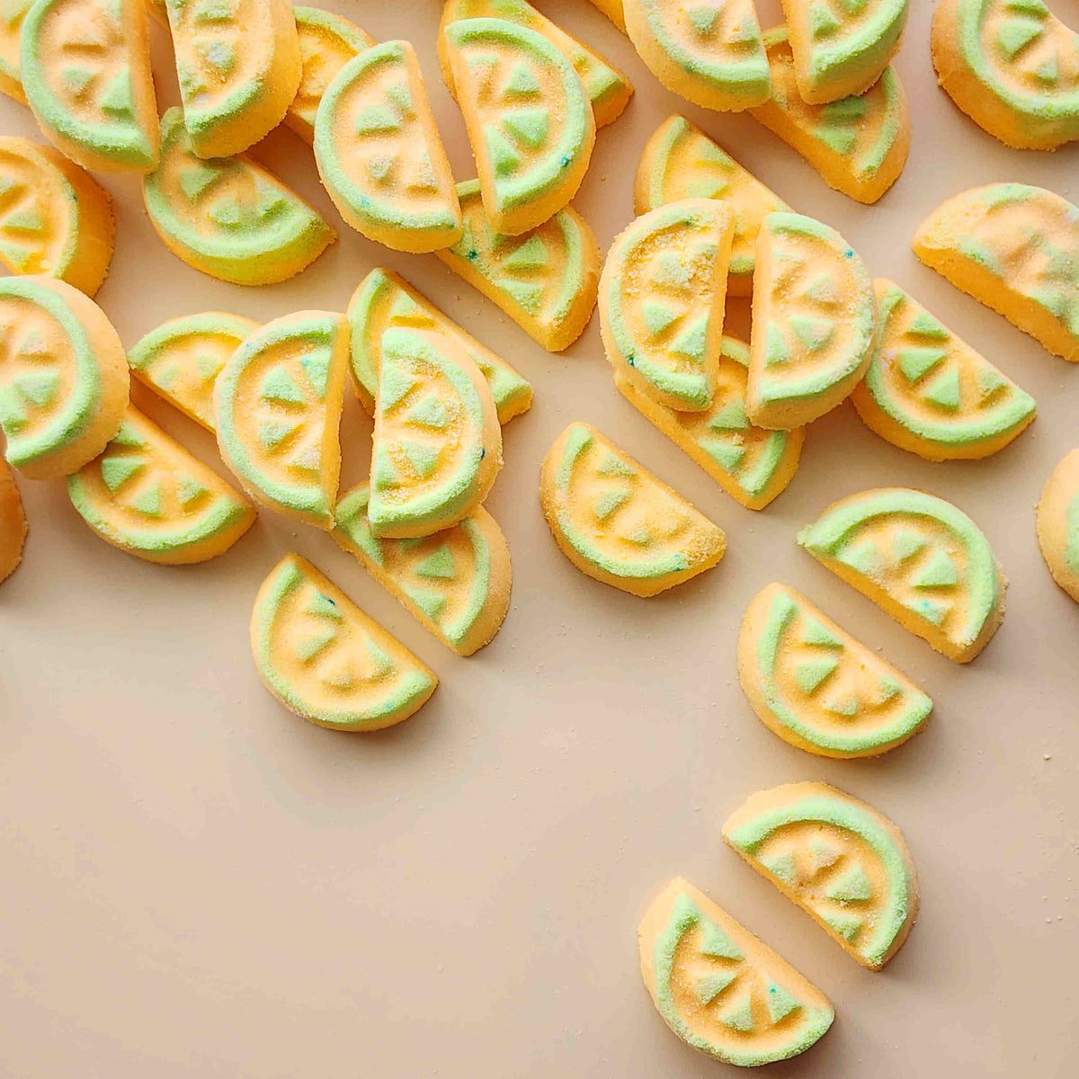 Overhead arrangement of honeydew-slice mini bath bombs