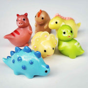 group of colourful round dinosaurs on a white background