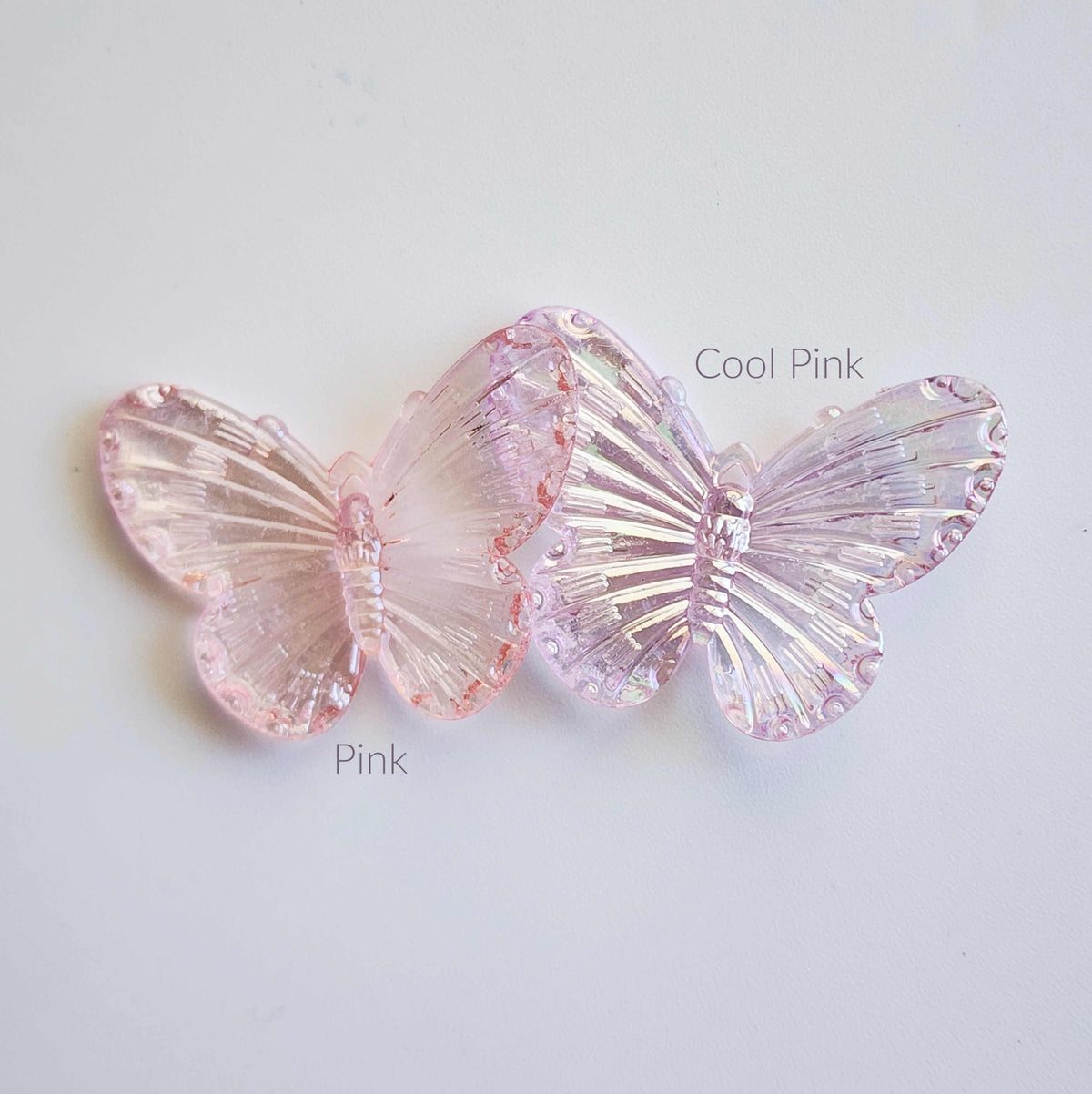 comparison of colours between pink and cool pink in the shape of butteflies